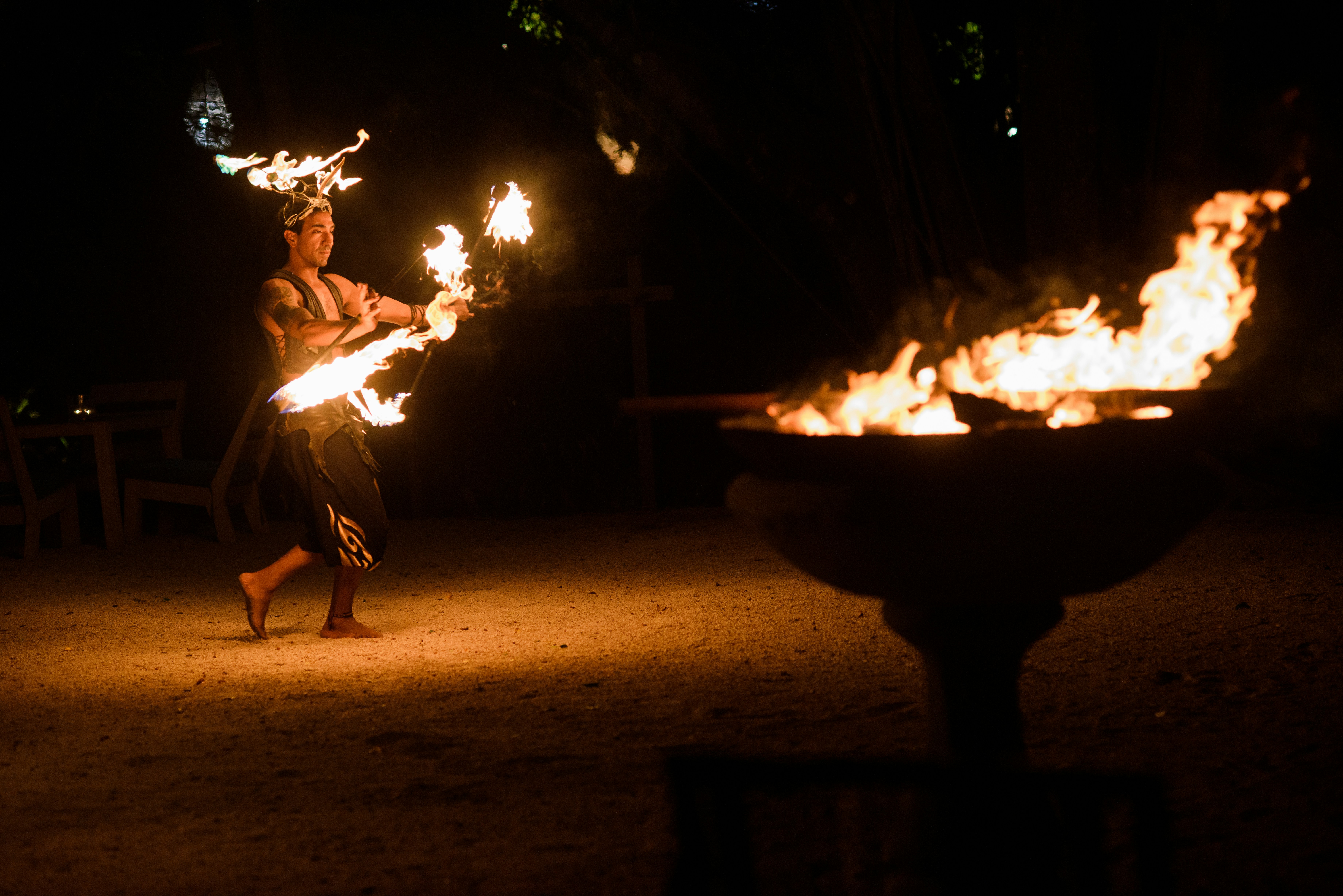 man firedancing on sand